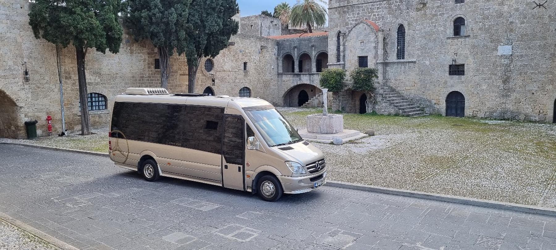 Luxury transfer vehicle in a historic city courtyard